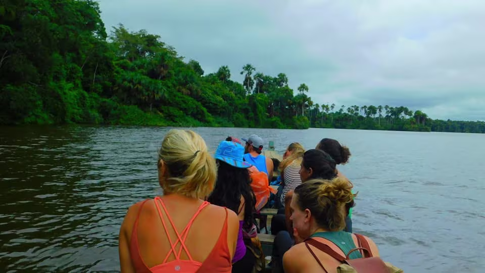 tourists on a boat tour in the Tambopata National Reserve in southeastern Peru, likely on Lake Sandoval, an oxbow lake renowned for its biodiversity puerto maldonado amazon tour